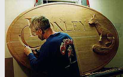 Malcolm carving a sign